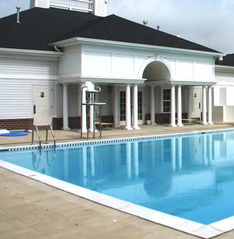 A large swimming pool in front of a building.