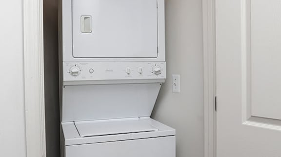 a white washer and dryer in a white room at Overland Gardens, Landover, MD 20785