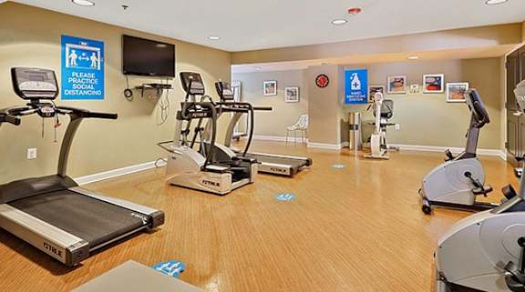 A gym with treadmills, elliptical machines and other exercise equipment. at Rainier Manor Apartments, Maryland