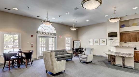 a living room with a kitchen and a table and chairs at Windsor Crossing, Maryland