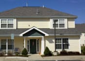 Thumbnail 2 of 4 - a yellow house with a green door