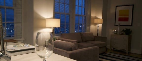 kitchen and living room illuminated by lamplight at dusk at Thomas Jefferson Tower