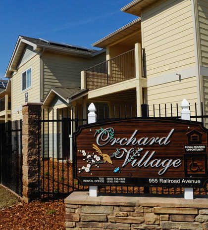 a sign in front of a row of houses