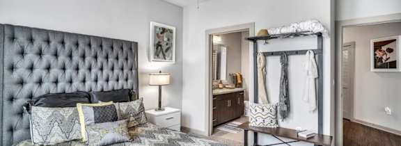 A bedroom with a large bed and a ceiling fan.