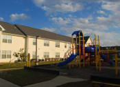 Thumbnail 3 of 4 - a playground in front of a building