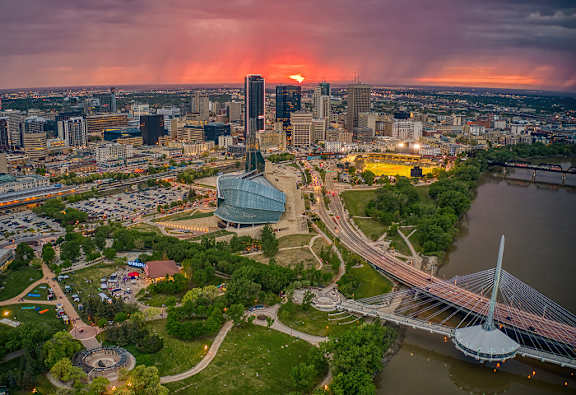 A cityscape with a river and a bridge.