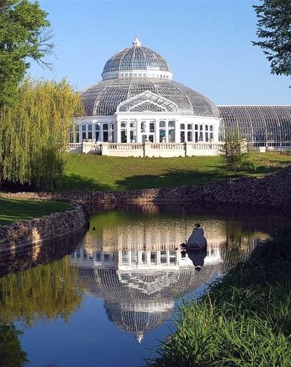 a reflection of a conservatory in a body of water