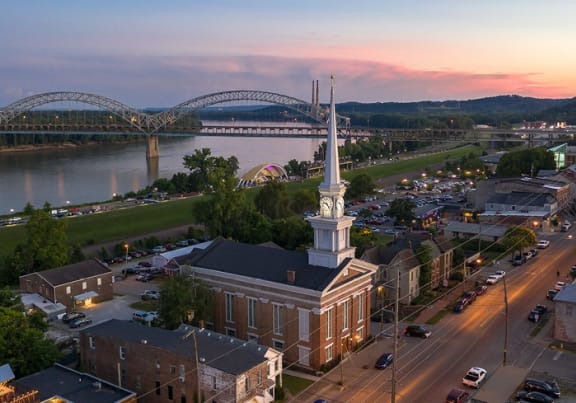 A cityscape with a prominent white tower and a bridge in the background. at HUB of New Albany Apartments, New Albany