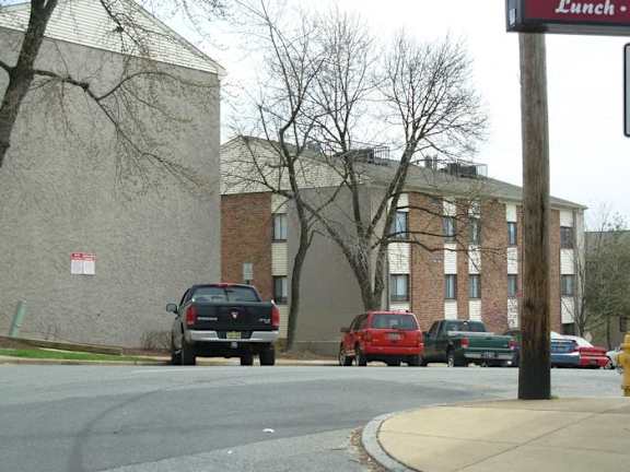 a street with cars parked in front of a building