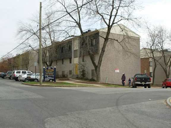 a building on the corner of a street with cars parked