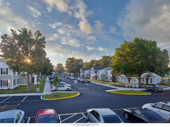 a rendering of a neighborhood with cars parked on the street