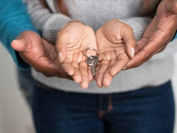 a woman holding keys in her hands