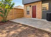 Thumbnail 5 of 15 - A red door is on the brick house.