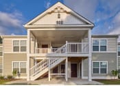 Thumbnail 1 of 6 - the exterior of a building with stairs and a porch