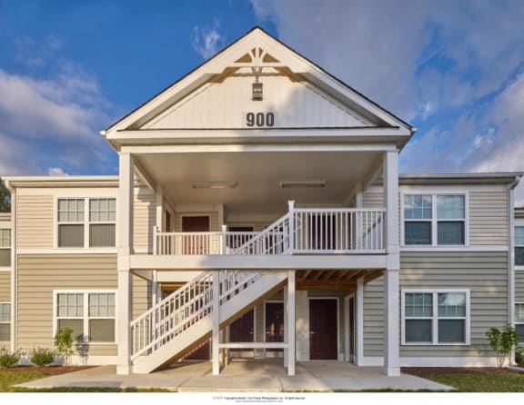 the exterior of a building with stairs and a porch