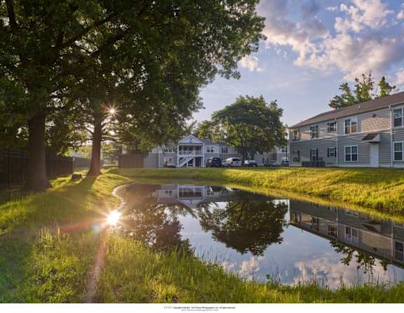 a row of townhomes with a sidewalk in front of them