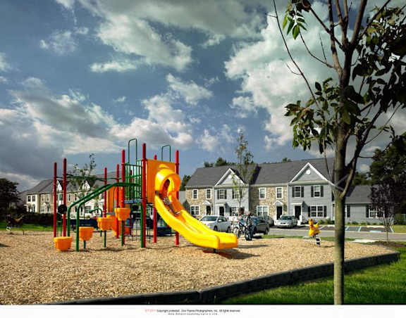 a large yellow slide on a playground in a park