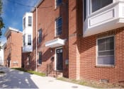 Thumbnail 4 of 4 - a brick building with a sidewalk in front of it
