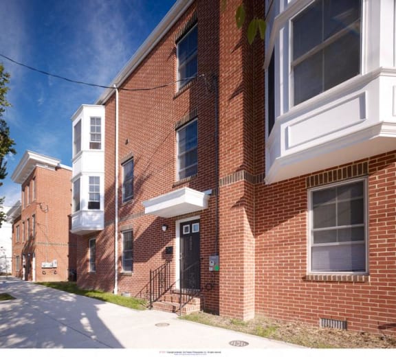 a brick building with a sidewalk in front of it