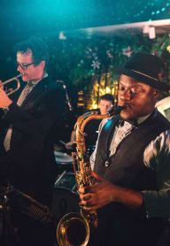 a man playing a saxophone in a jazz band