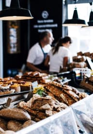 a display of bread and other baked goods at a bakery