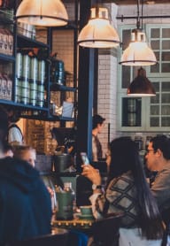 people sitting at tables in a restaurant