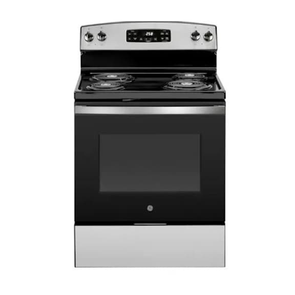 A modern stove top with a glass cooking surface and a stainless steel oven.