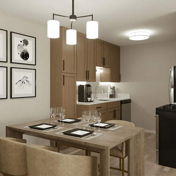 A modern dining room with a wooden table set for two.