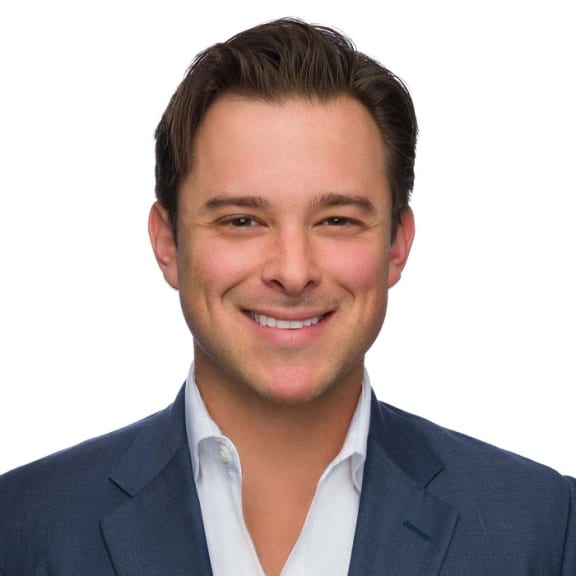 a young man in a suit and tie smiling