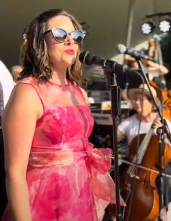 image may contain  person  on stage and playing a musical instrument