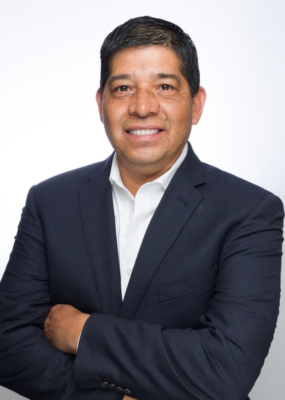 a man in a suit with his arms crossed