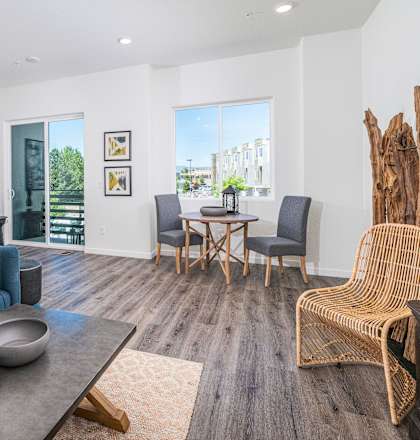 a living room with white walls and hardwood floors