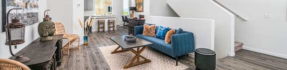 a living room with white walls and a blue couch