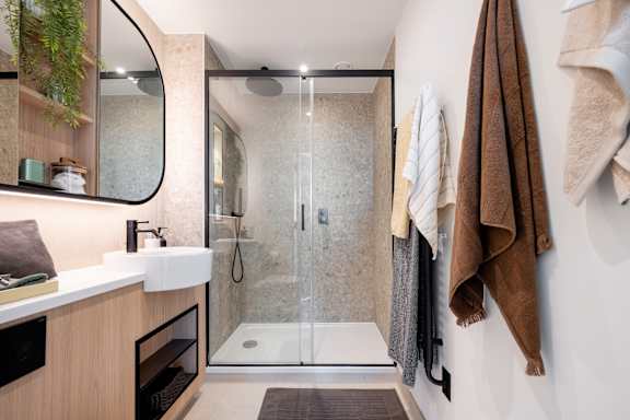 A bathroom with a walk-in shower and a sink.
