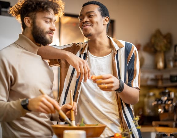 two men cooking in a kitchen