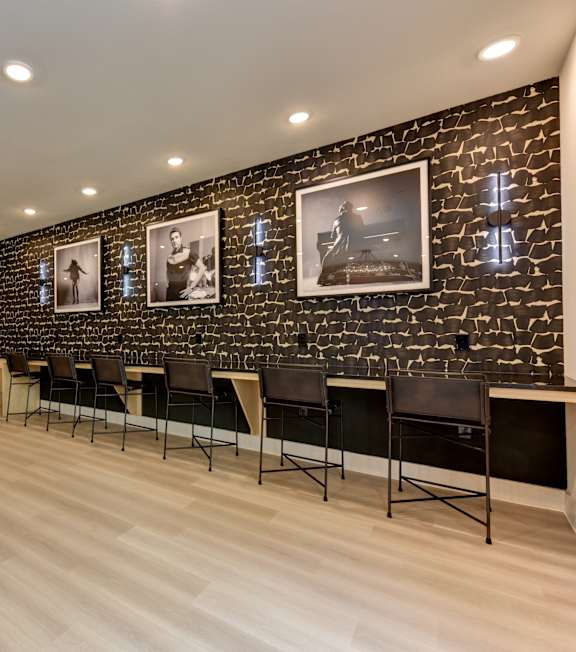 A spacious gym with a variety of equipment including a treadmill, weight bench, and exercise machines.