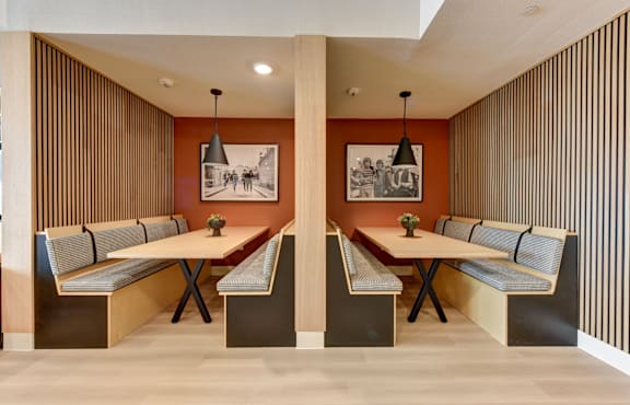 A modern dining room with a long table and chairs.