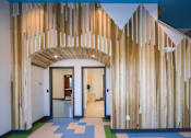 Thumbnail 6 of 7 - A hallway with a blue and white checkered floor and a wooden wall.