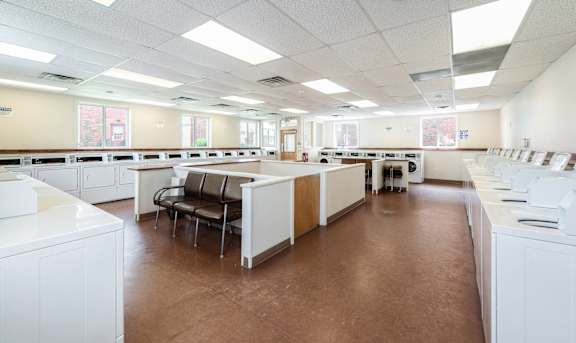A laundry room with washers and dryers at Coppermine Village Apartment, Bristol, CT, 06010
