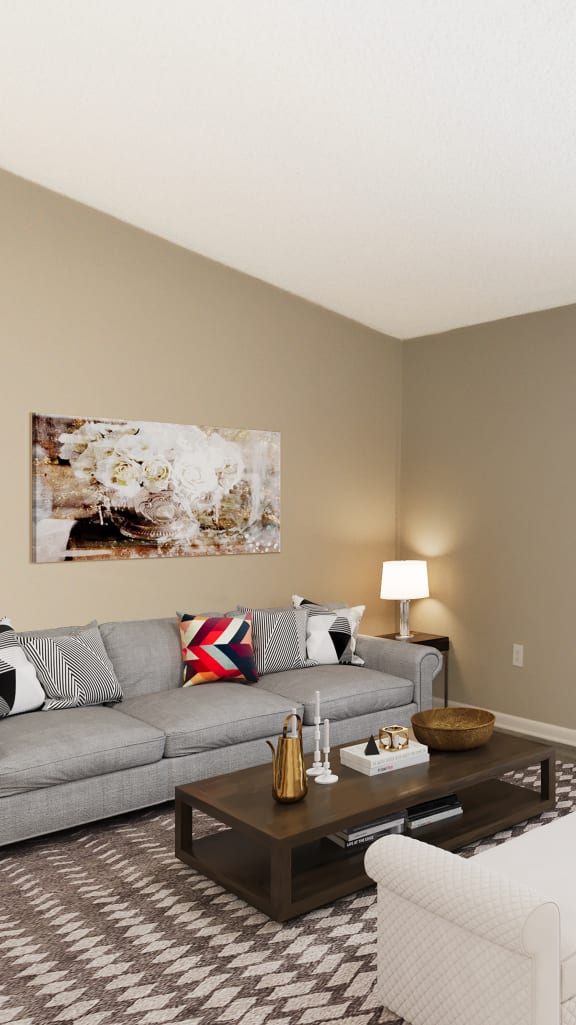 a living room with a couch and a chair and a sliding glass door at Aqua Bay Apartments in Naples, FL 34116
