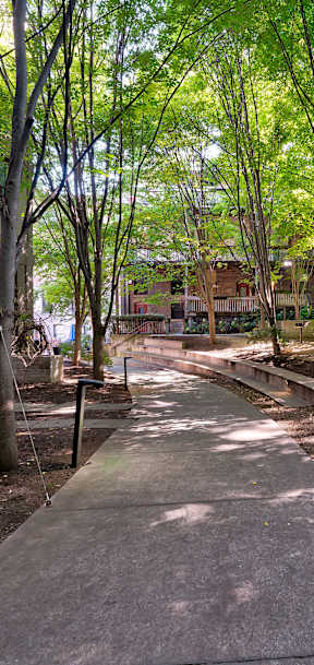 A long corridor with brick walls and a concrete floor.