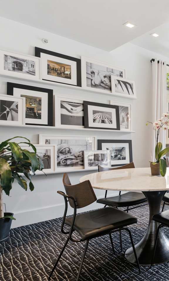 A modern living room with a round table and chairs.