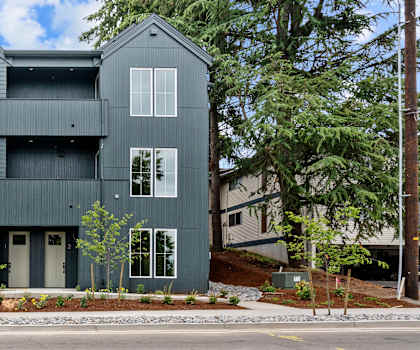 A modern two-story house with a flat roof and large windows.