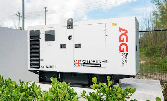 A white generator with the letters AGG on the side is parked outside.