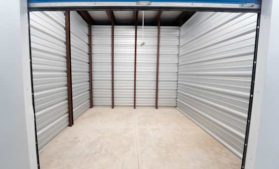 A storage unit with a closed white door and a closed brown door.