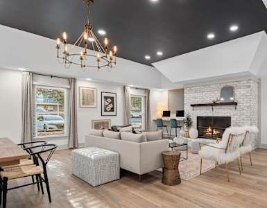 a living room with couches and chairs and a fireplace