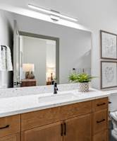 A white bathroom with a toilet, sink, and shower curtain.