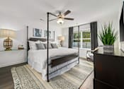 Thumbnail 5 of 6 - A bedroom with a large bed and a ceiling fan.