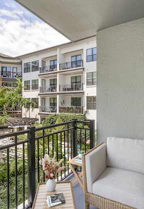 a large living room with a pool table and a fireplace at The District at Rosemary, Sarasota, FL, 34236