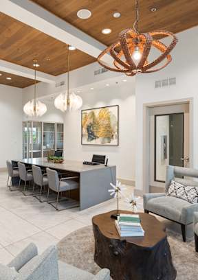 A modern living room with a wooden ceiling and a large window.
